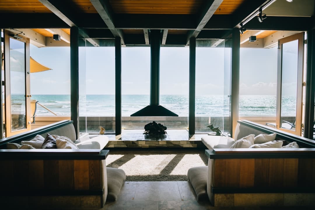 A professionally staged vacation rental living room with coastal decor and natural lighting
